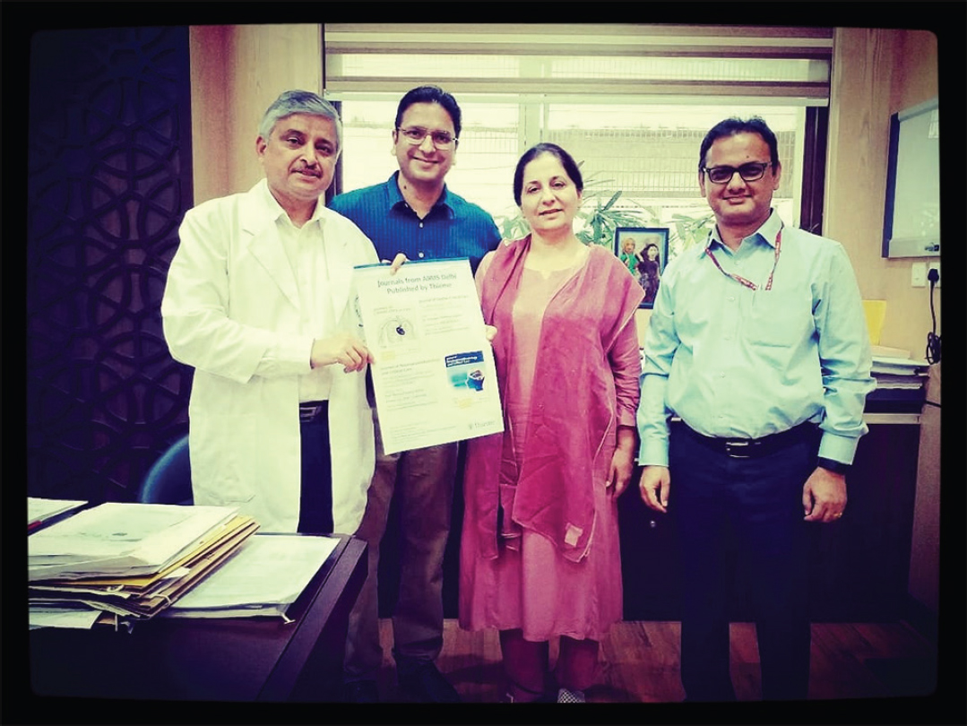 Display of the journal poster at the Director Office, A.I.I.M.S., New Delhi. From left to right: Prof. Randeep Guleria, Director A.I.I.M.S., New Delhi; Dr. Sunny Duttagupta, Senior Acquisitions Editor, Thieme Medical and Scientific Publishers, India; Prof. Poonam Malhotra Kapoor, Editor-in-Chief, Journal of Cardiac Critical Care, Secretary and Chairman Academics – The Simulation Society; and Prof. Girija Rath, Editor, Journal of Neuroanesthesiology and Critical Care. A.I.I.M.S., All India Institute of Medial Sciences.