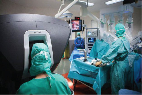 The robots with the physician doing work 3D behind the console.