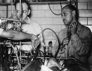 Dr. Frank Gollan (on right) and Dr. Clark L.C., Jr. (on left) experimenting with bubble oxygenator.